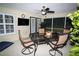 A screened patio with a dining table, chairs, ceiling fan and mounted TV at 6011 Country Walk Ln, Winter Haven, FL 33880
