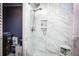 Elegant walk-in shower with marble tiling and built-in shelving at 6011 Country Walk Ln, Winter Haven, FL 33880