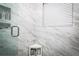 Elegant walk-in shower with marble tiling and built-in shelving at 6011 Country Walk Ln, Winter Haven, FL 33880