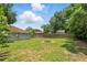 Spacious backyard with wooden fence and fire pit at 608 Swanson St, Groveland, FL 34736