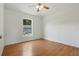 Bright bedroom with wood flooring and a window that offers a refreshing view of the outdoors at 608 Swanson St, Groveland, FL 34736