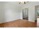 Bright bedroom features wood floors, a ceiling fan and a closet with sliding mirror doors at 608 Swanson St, Groveland, FL 34736