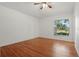 Bright bedroom with wood flooring and a window that offers a refreshing view of the outdoors at 608 Swanson St, Groveland, FL 34736