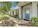 Charming single-story home with a blue front door, well-manicured landscaping, and a welcoming walkway at 608 Swanson St, Groveland, FL 34736