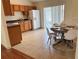 Eat-in kitchen with tile floors, wooden cabinets, laminate countertops, and stainless steel appliances at 608 Swanson St, Groveland, FL 34736