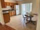 Eat-in kitchen with tile floors, wooden cabinets, laminate countertops, and stainless steel appliances at 608 Swanson St, Groveland, FL 34736