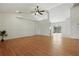 Bright and airy living room featuring wood laminate floors, ceiling fan, and recessed lighting at 608 Swanson St, Groveland, FL 34736