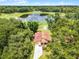 Aerial view of the home with a red tile roof surrounded by lush greenery and a nearby golf course at 6301 Parson Brown Dr, Orlando, FL 32819