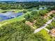 Aerial view of the property surrounded by lush greenery and a nearby golf course and lake at 6301 Parson Brown Dr, Orlando, FL 32819