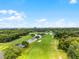 Stunning aerial shot overlooking the golf course with views of the water and a distant city skyline at 6301 Parson Brown Dr, Orlando, FL 32819