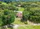 Expansive aerial view of charming home featuring lush green landscaping and mature trees, close to golf course at 6301 Parson Brown Dr, Orlando, FL 32819