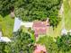 Aerial view of home surrounded by trees with well-maintained garden and landscaping at 6301 Parson Brown Dr, Orlando, FL 32819