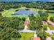 Beautiful aerial view of home nestled on golf course lot with mature trees and lush landscaping at 6301 Parson Brown Dr, Orlando, FL 32819