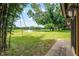 Expansive backyard with lush greenery and scenic views of the golf course beyond mature trees at 6301 Parson Brown Dr, Orlando, FL 32819
