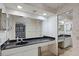 The bathroom features a sink with vanity, lighting, large mirror, and leaf-themed wallpaper at 6301 Parson Brown Dr, Orlando, FL 32819