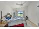 Bright bedroom with neutral carpet, a ceiling fan, and views of the golf course at 6301 Parson Brown Dr, Orlando, FL 32819