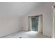Vacant bedroom boasting vaulted ceilings, neutral carpet, and a sliding door for natural light at 6301 Parson Brown Dr, Orlando, FL 32819