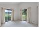 Empty bedroom featuring vaulted ceilings, neutral carpet, and sliding glass doors at 6301 Parson Brown Dr, Orlando, FL 32819