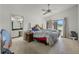 Comfortable bedroom featuring a ceiling fan, neutral carpet, and an ensuite bathroom at 6301 Parson Brown Dr, Orlando, FL 32819