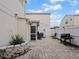 Backyard patio with brick pavers, fenced yard, and a grill at 750 Olympic Cir # D1, Ocoee, FL 34761