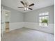 Bedroom featuring a ceiling fan, window, and access to an ensuite bathroom at 750 Olympic Cir # D1, Ocoee, FL 34761