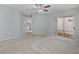Bedroom showcasing neutral carpet, ceiling fan, and sliding door access to screened patio at 750 Olympic Cir # D1, Ocoee, FL 34761