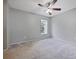 Bright bedroom features neutral carpeting, paint, a ceiling fan, and a window that provides plenty of natural light at 750 Olympic Cir # D1, Ocoee, FL 34761