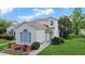 Inviting two-story home with manicured lawn, mature trees, and arched window at 750 Olympic Cir # D1, Ocoee, FL 34761