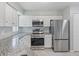 Modern kitchen featuring stainless steel appliances and granite countertops at 750 Olympic Cir # D1, Ocoee, FL 34761