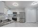Bright kitchen featuring stainless steel appliances, modern fixtures, and sleek white cabinetry at 750 Olympic Cir # D1, Ocoee, FL 34761