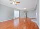 Bright, open living area with hardwood flooring, ceiling fan, and neutral paint at 750 Olympic Cir # D1, Ocoee, FL 34761
