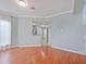 Spacious living room featuring hardwood floors, staircase, and natural light at 750 Olympic Cir # D1, Ocoee, FL 34761
