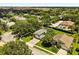 Aerial view of a single Gathering home surrounded by mature trees, green lawns, and a screened pool enclosure at 901 Grovesmere Loop, Ocoee, FL 34761