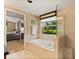 Bright bathroom with a soaking tub and walk-in shower, seamlessly connected to the main bedroom at 901 Grovesmere Loop, Ocoee, FL 34761