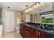 Modern bathroom with double vanity, updated fixtures, and a spacious glass-enclosed shower at 901 Grovesmere Loop, Ocoee, FL 34761