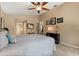Cozy bedroom features a ceiling fan, neutral paint, and well-placed art at 901 Grovesmere Loop, Ocoee, FL 34761