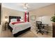 Bright bedroom with a ceiling fan, neutral paint, a work desk, and a red accent at 901 Grovesmere Loop, Ocoee, FL 34761