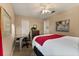 Inviting bedroom with a ceiling fan, neutral paint, and a desk area near the window at 901 Grovesmere Loop, Ocoee, FL 34761