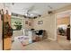 Versatile bonus room with a desk, storage shelves, and a brightly colored rug at 901 Grovesmere Loop, Ocoee, FL 34761