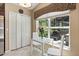 Bright breakfast nook by the kitchen with a view of the outdoor patio and modern white table and chairs at 901 Grovesmere Loop, Ocoee, FL 34761
