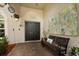 Charming front porch with double door entry, decorated with bench, plants, and an art piece at 901 Grovesmere Loop, Ocoee, FL 34761