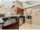 Modern kitchen featuring granite countertops, stainless steel appliances, and a breakfast bar overlooking the living area at 901 Grovesmere Loop, Ocoee, FL 34761