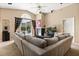 Comfortable living room featuring a large sectional sofa, fireplace, and sliding door access to the outdoors at 901 Grovesmere Loop, Ocoee, FL 34761