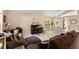 Cozy living room with comfortable seating, piano, and a view of the backyard at 901 Grovesmere Loop, Ocoee, FL 34761