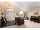 Spacious living room with high ceiling, large windows, and a piano at 901 Grovesmere Loop, Ocoee, FL 34761