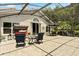 Spacious screened-in patio featuring comfortable outdoor furniture, perfect for entertaining and enjoying the outdoors at 901 Grovesmere Loop, Ocoee, FL 34761