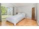 A bright bedroom with hardwood floors and sliding glass doors to the outdoor space and a neutral color palette at 9355 Telfer Run, Orlando, FL 32817