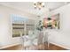 Bright dining room with modern table and chairs, complemented by hardwood flooring at 9355 Telfer Run, Orlando, FL 32817