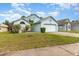Charming light blue single-story home with well-maintained lawn and an inviting curb appeal at 9355 Telfer Run, Orlando, FL 32817