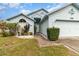 Attractive light blue single-story home with manicured landscaping and a welcoming front entrance at 9355 Telfer Run, Orlando, FL 32817